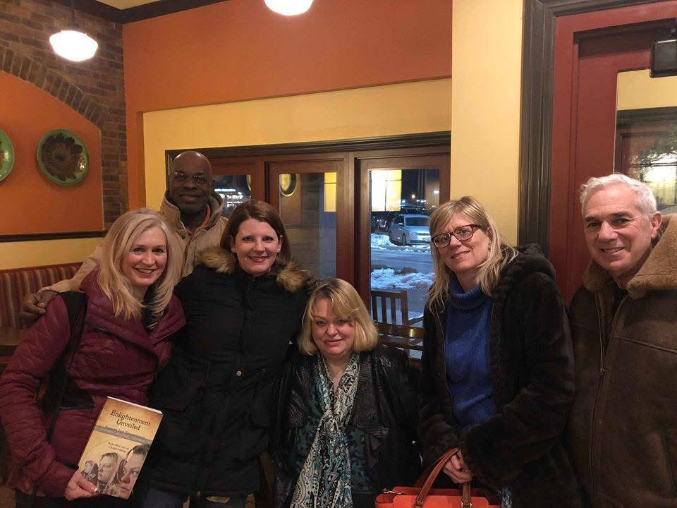 Photo of Jen Ward and healing retreat participants in a cafe