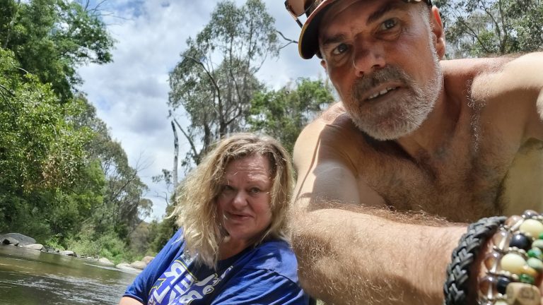 Photo of Jen Ward and Marvin Schneider swimming in a campsite creek