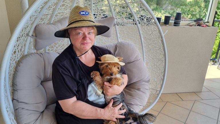 Photo of Jen Ward with her dog Maisie sitting in a swing