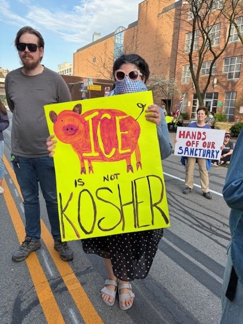 Photo of protester holding sign saying "ICE is not Kosher"