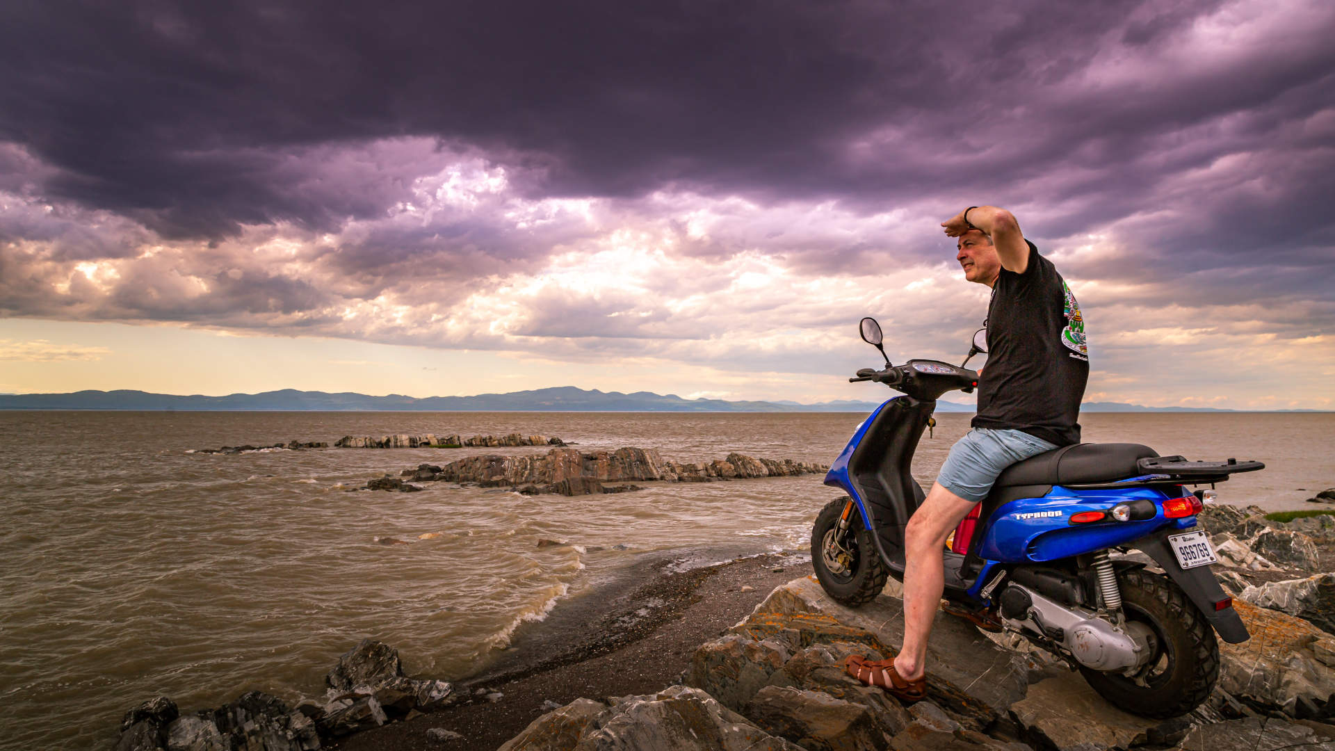 Hero image of man on a motorbike search the horizon