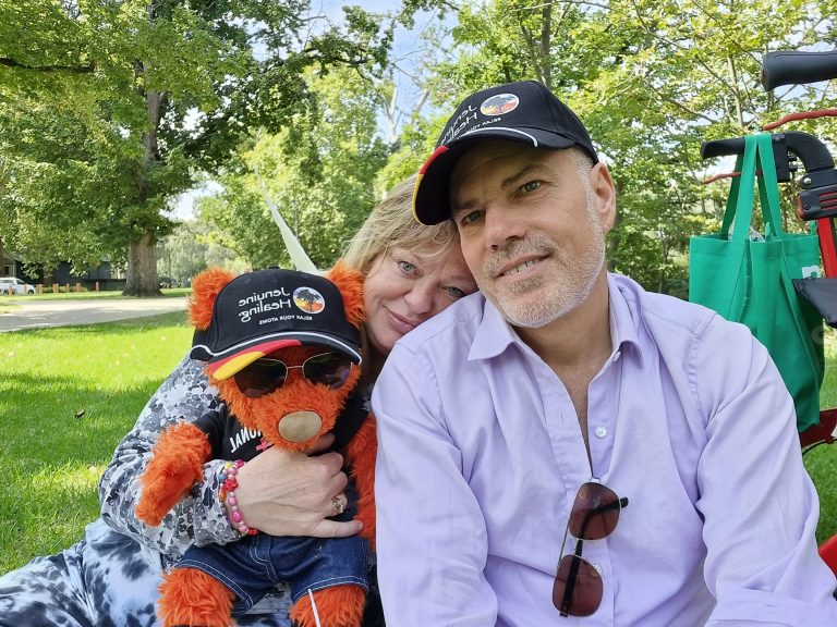 Photo of Jen Ward and Marvin Schneider with their healing bear Darshan